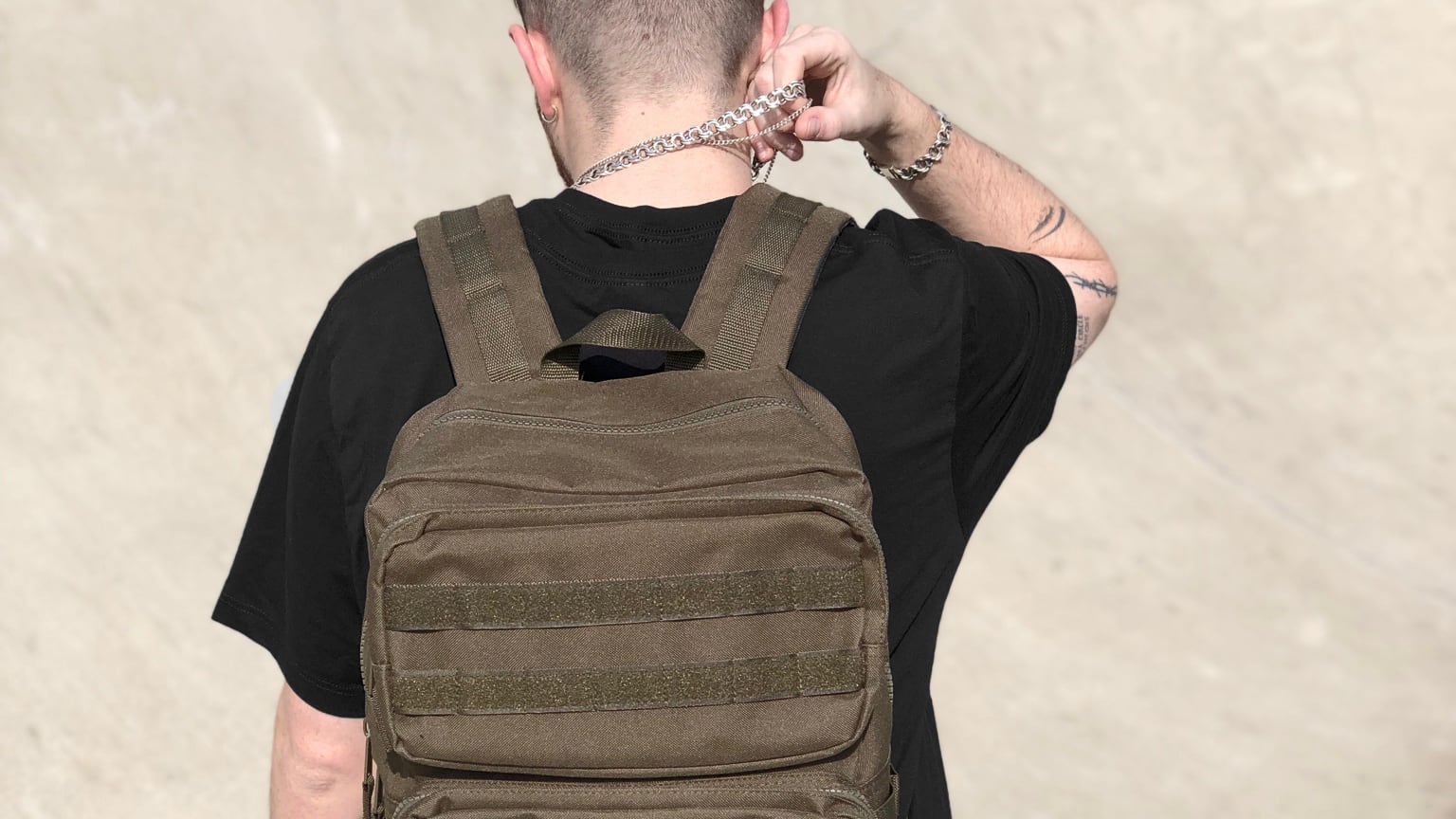 Model wearing the Tactical Bag in military green