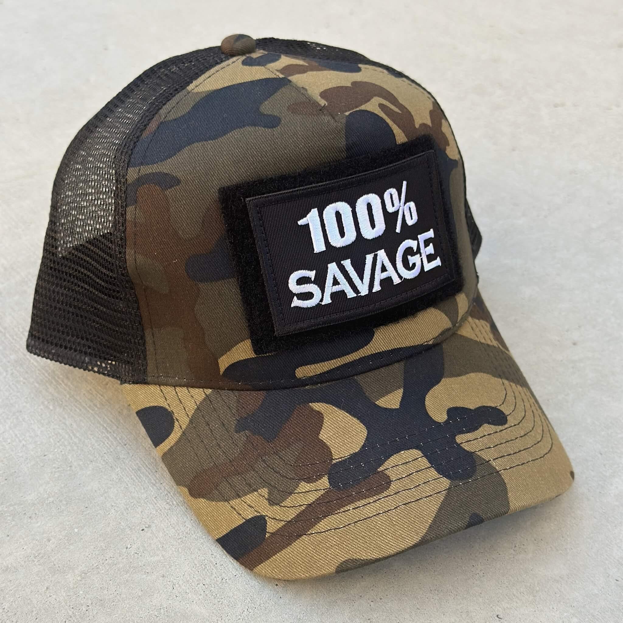 The trucker snapback cap in camo colors with 100% Savage patch attached