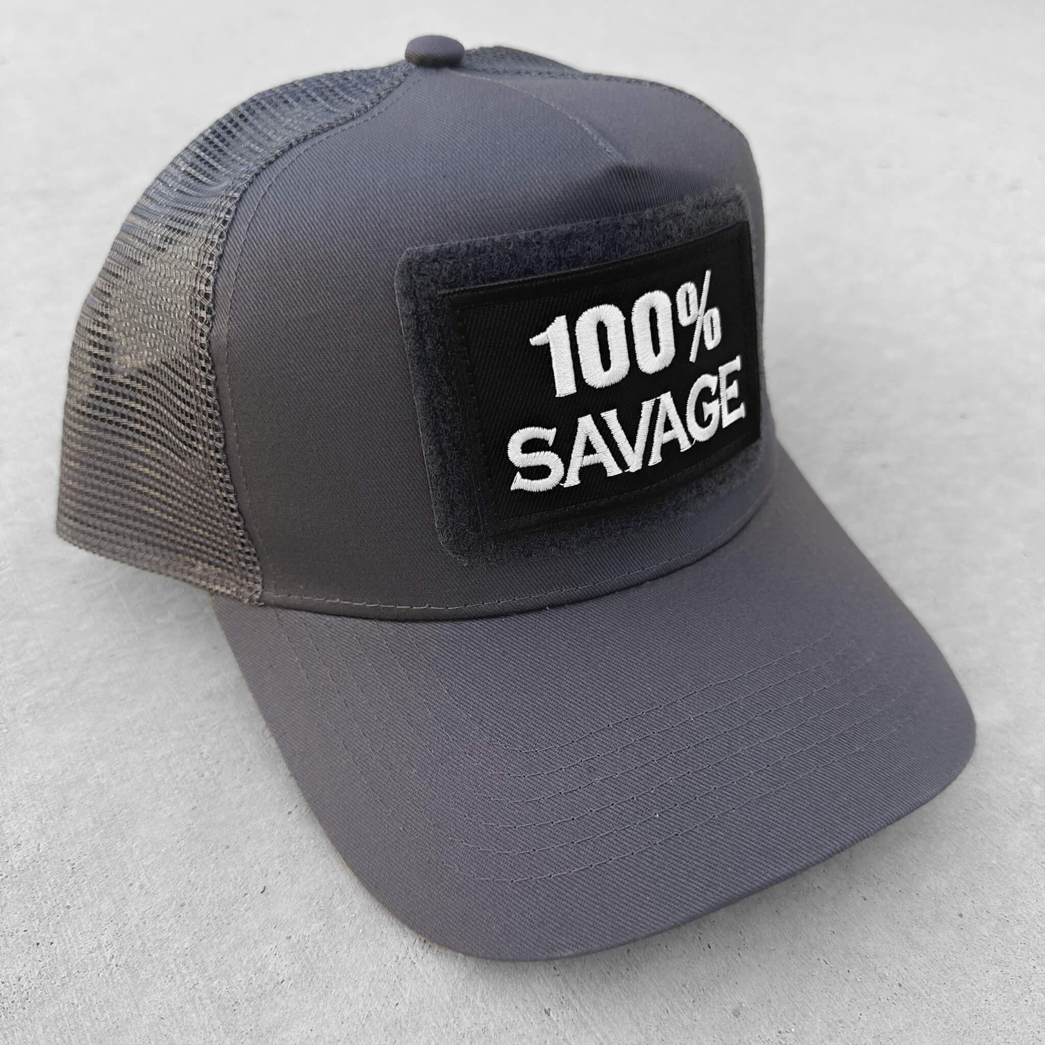 The trucker snapback cap in grey colors with 100% Savage patch attached