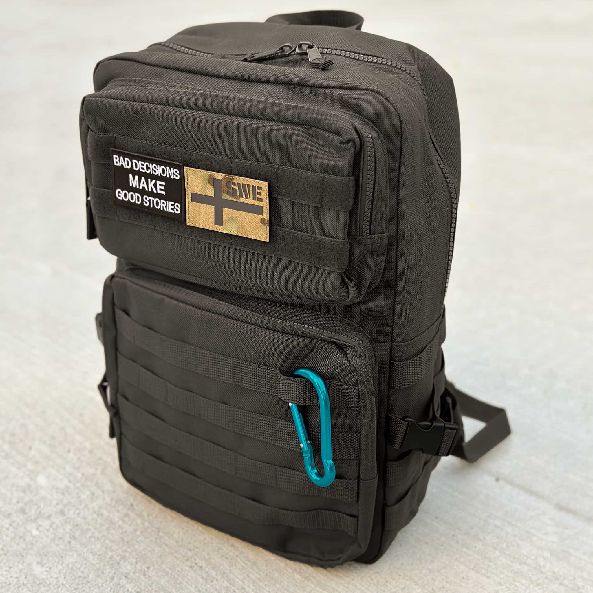 The Tactical Bag in black with hook and loop areas and MOLLE system on the back